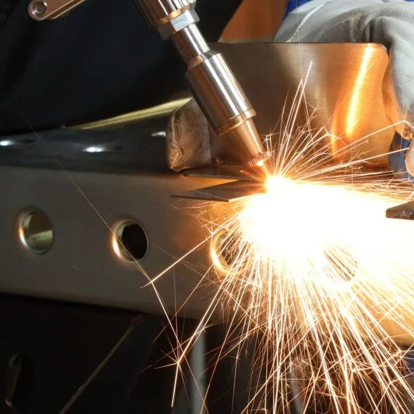 Operator handheld laser welding a steel bracket